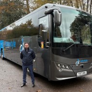 Driver stood next to Turbo style coach
